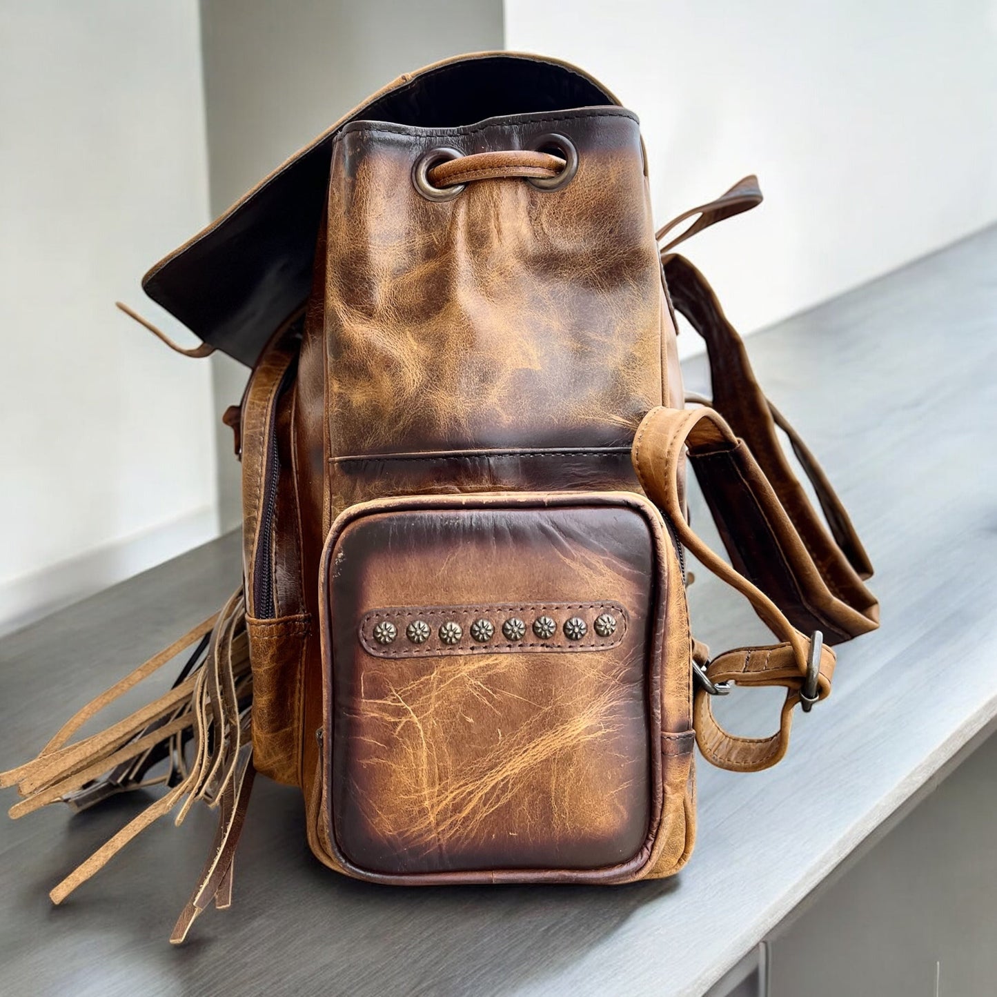Tooled leather fringe backpack
