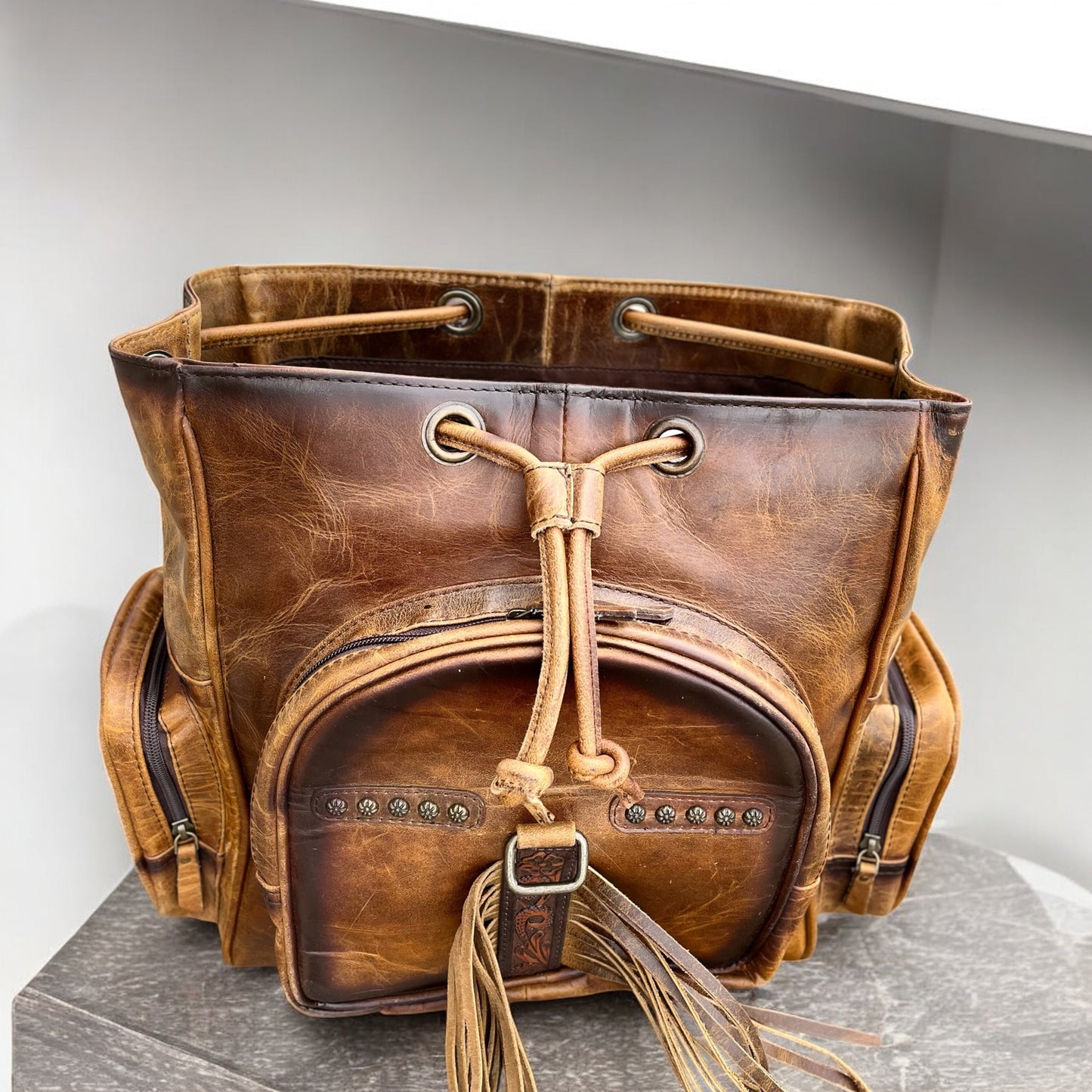 Tooled leather fringe backpack